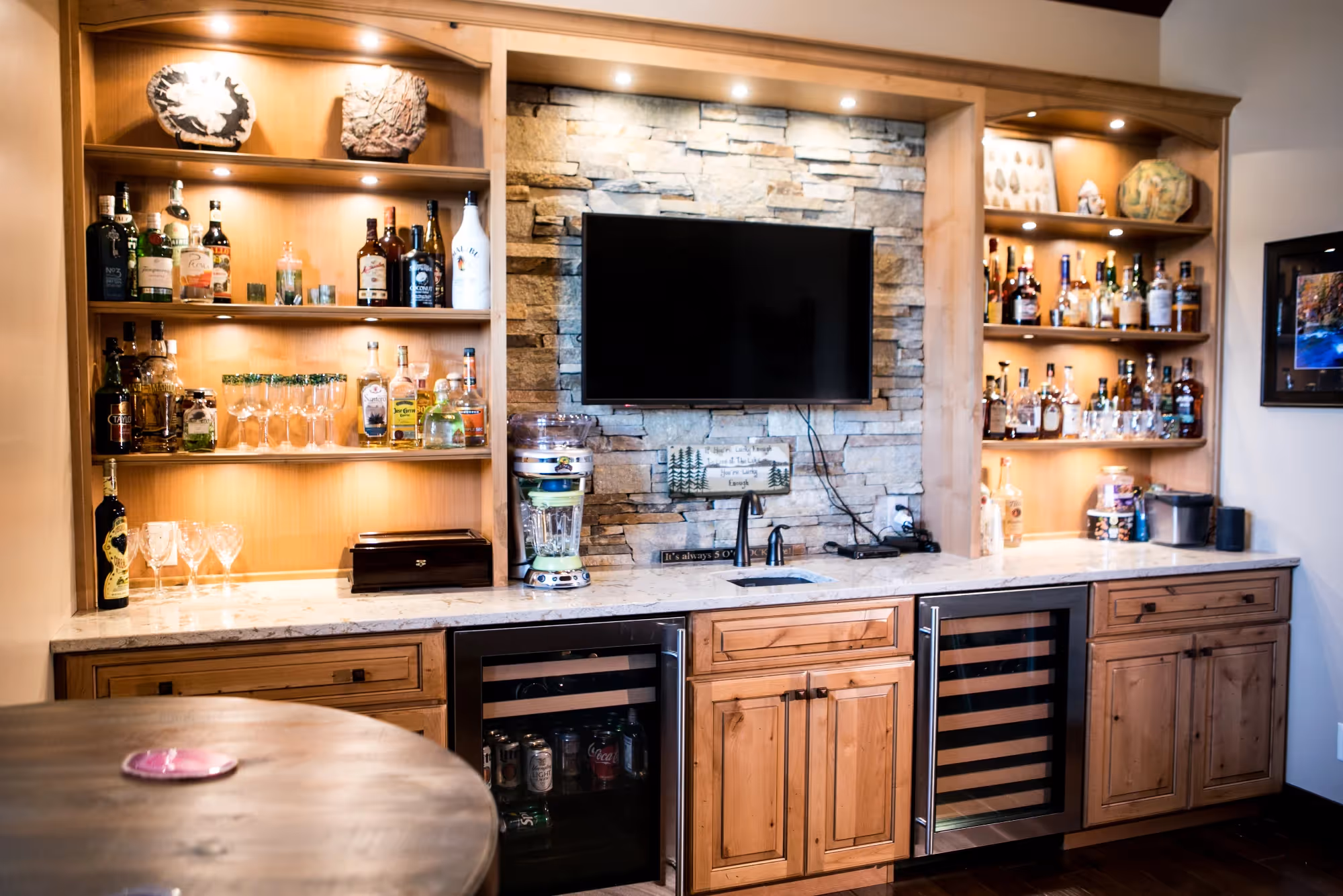 Living room entertainment area with warm wood shelving and TV.