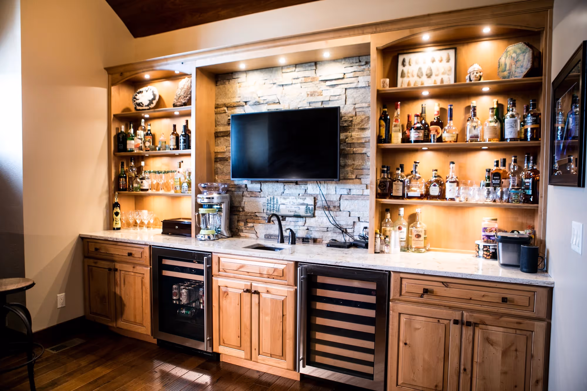 Living room with white and wooden entertainment cabinets and TV.