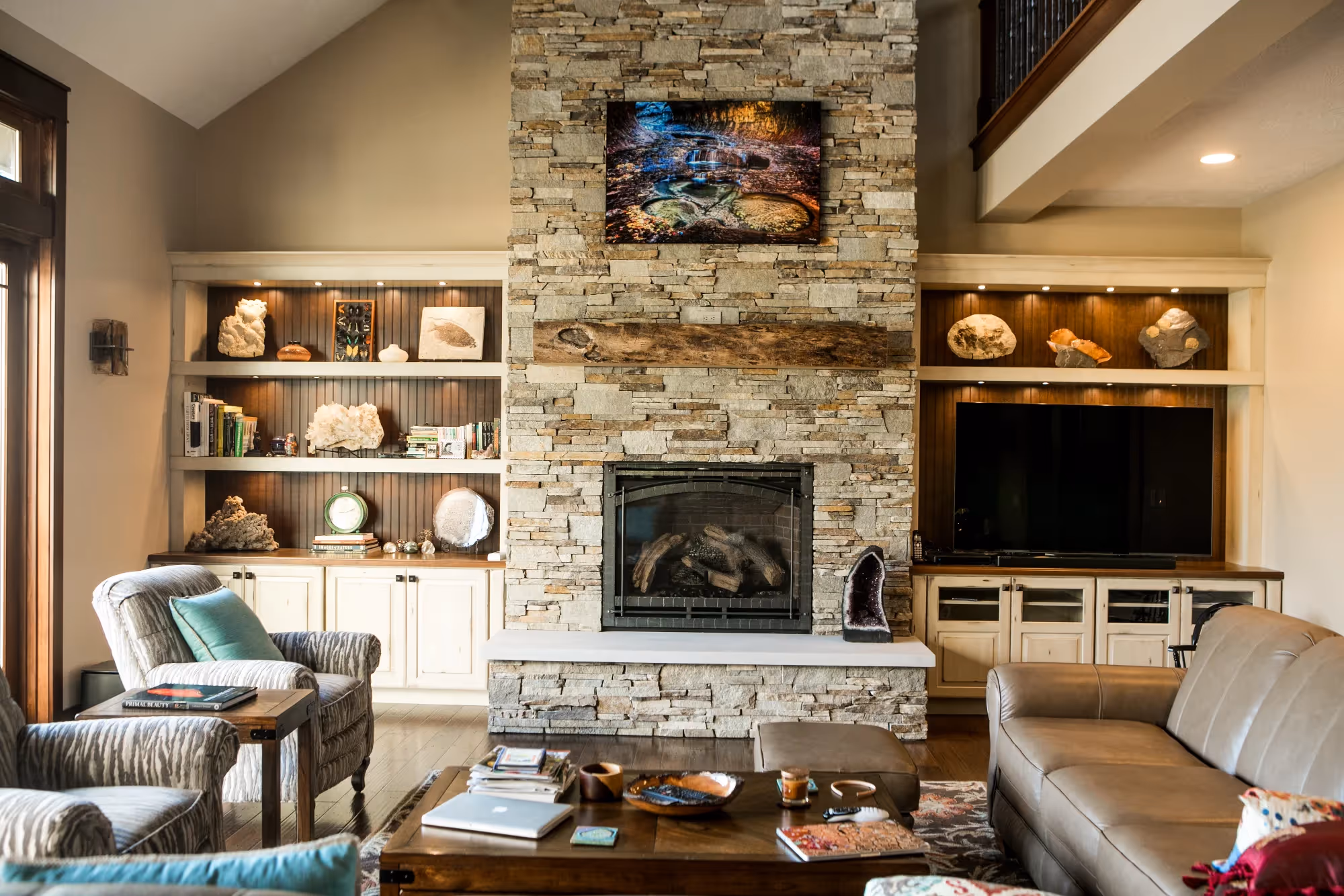 Living room with built-in shelves, fireplace, and mounted TV.
