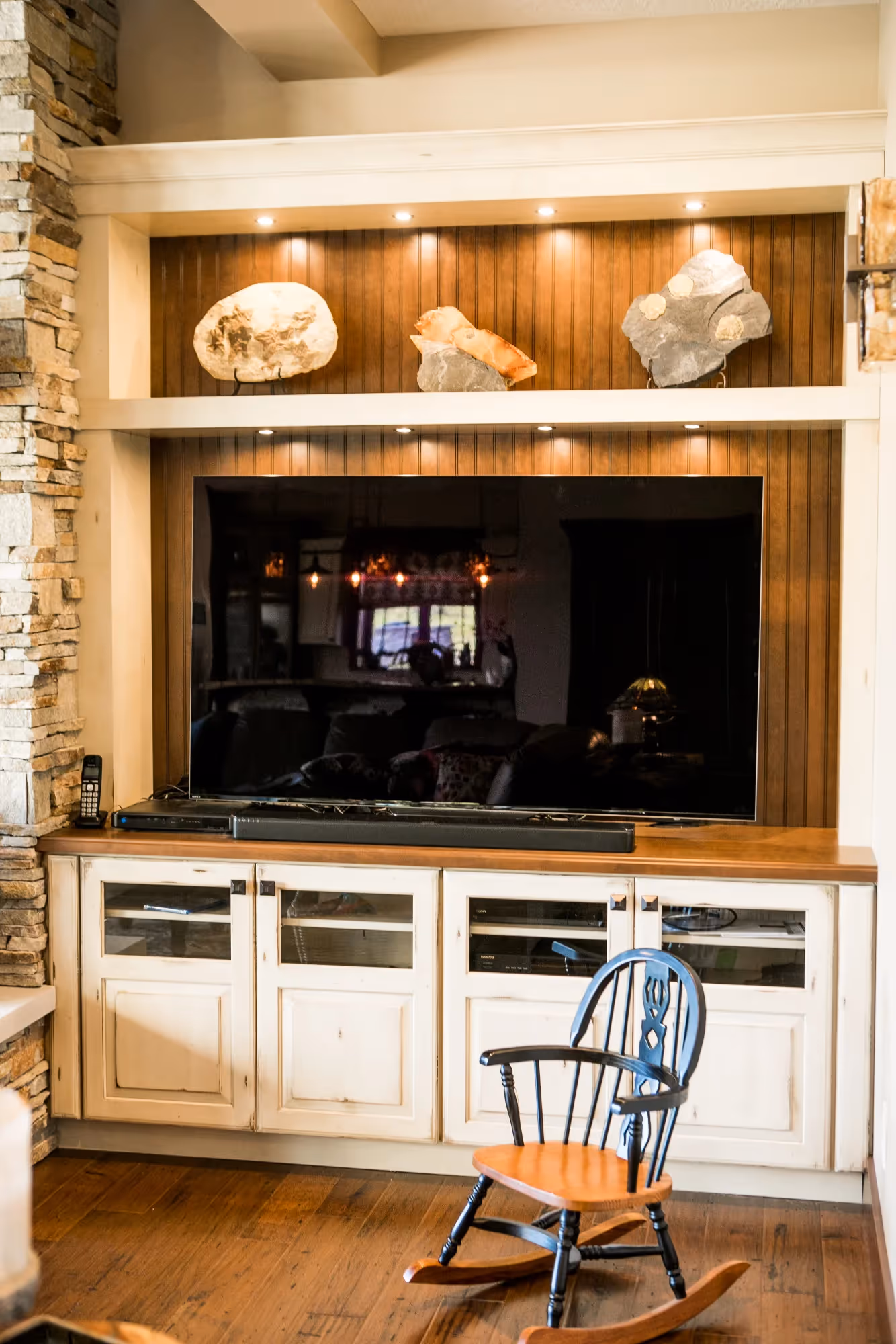 Cozy living room with wooden built-in cabinets and open shelves.