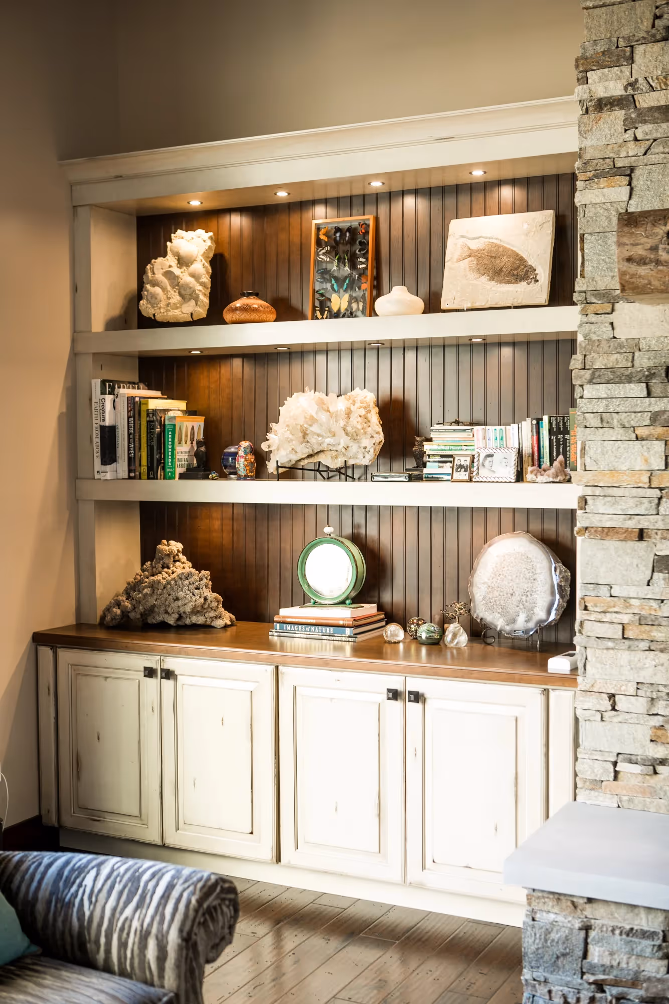 Modern built-in shelving unit with decorative lighting.