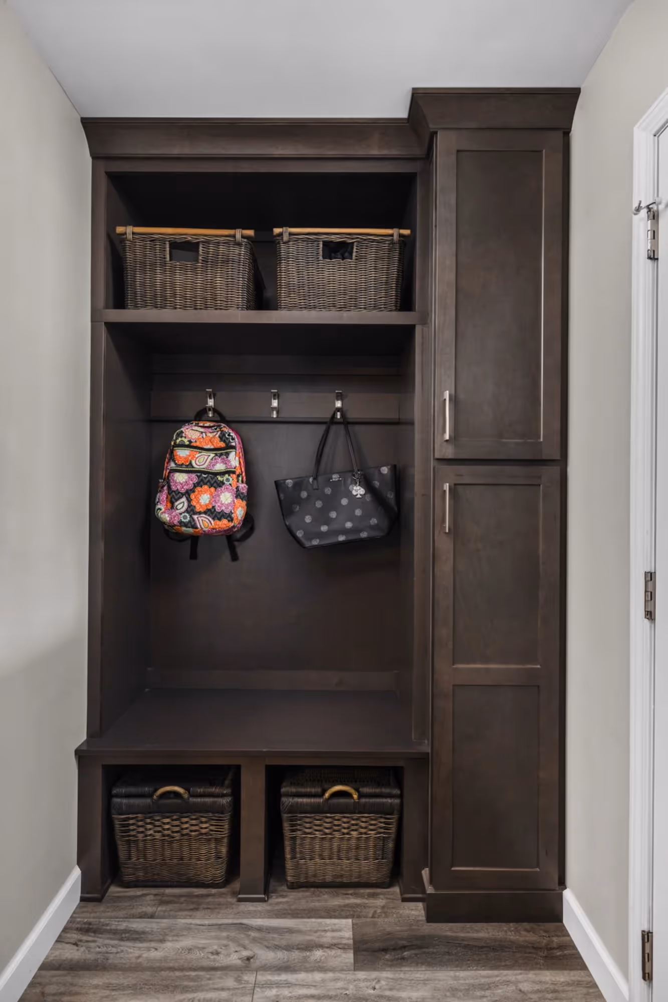 Built-in closet or pantry with shelving and a decorative piece.