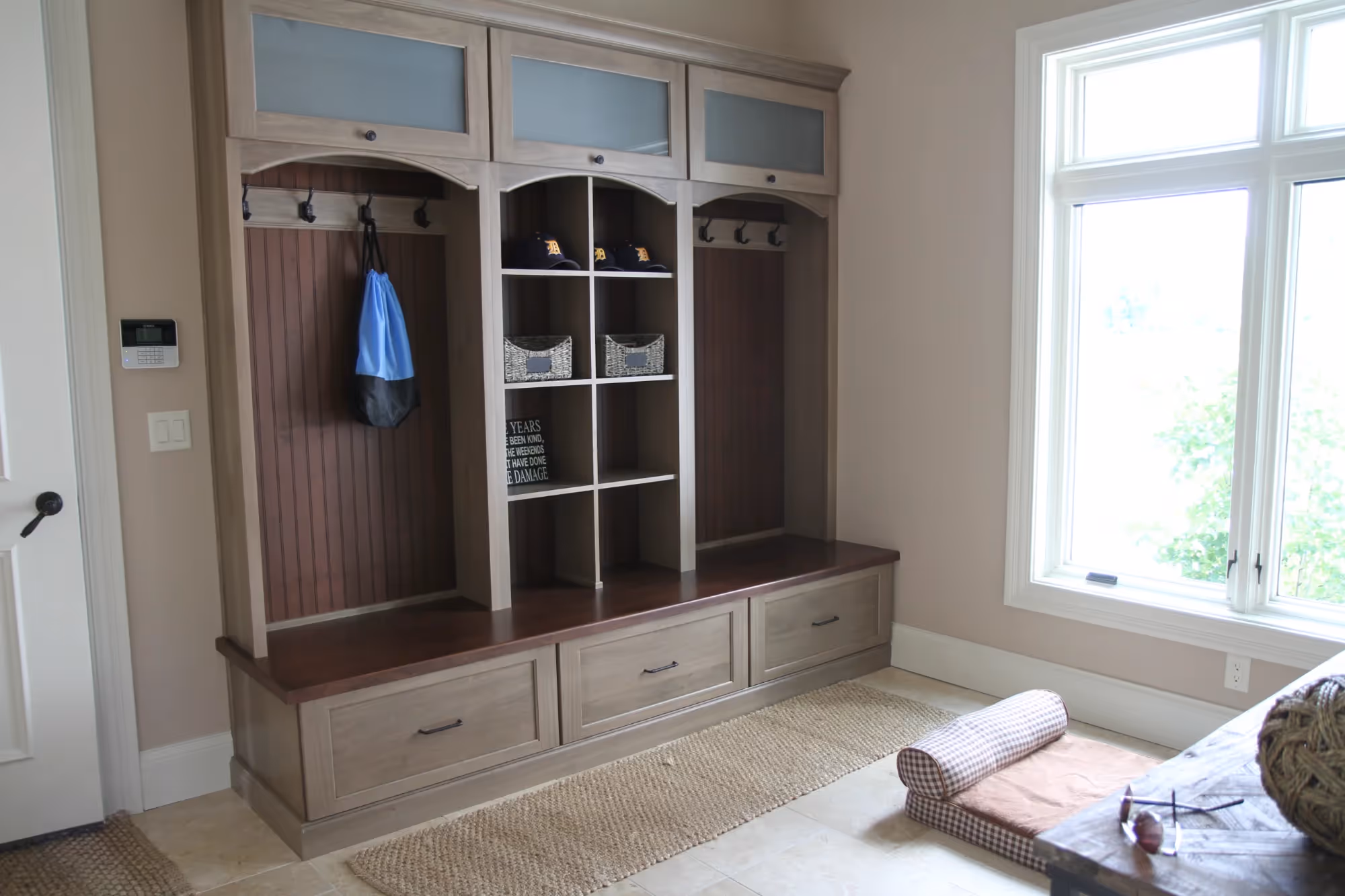 Built-in entertainment unit beside a bright window.