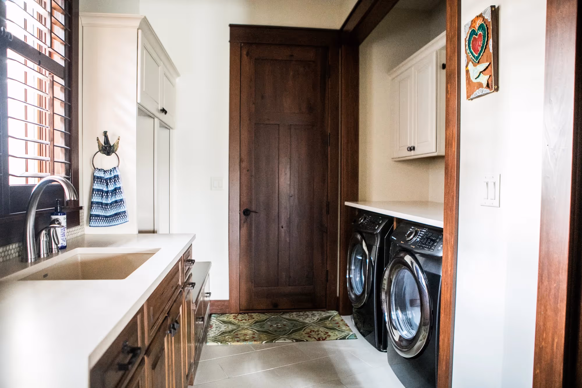 Laundry area with countertop, cabinets, and washer-dryer
