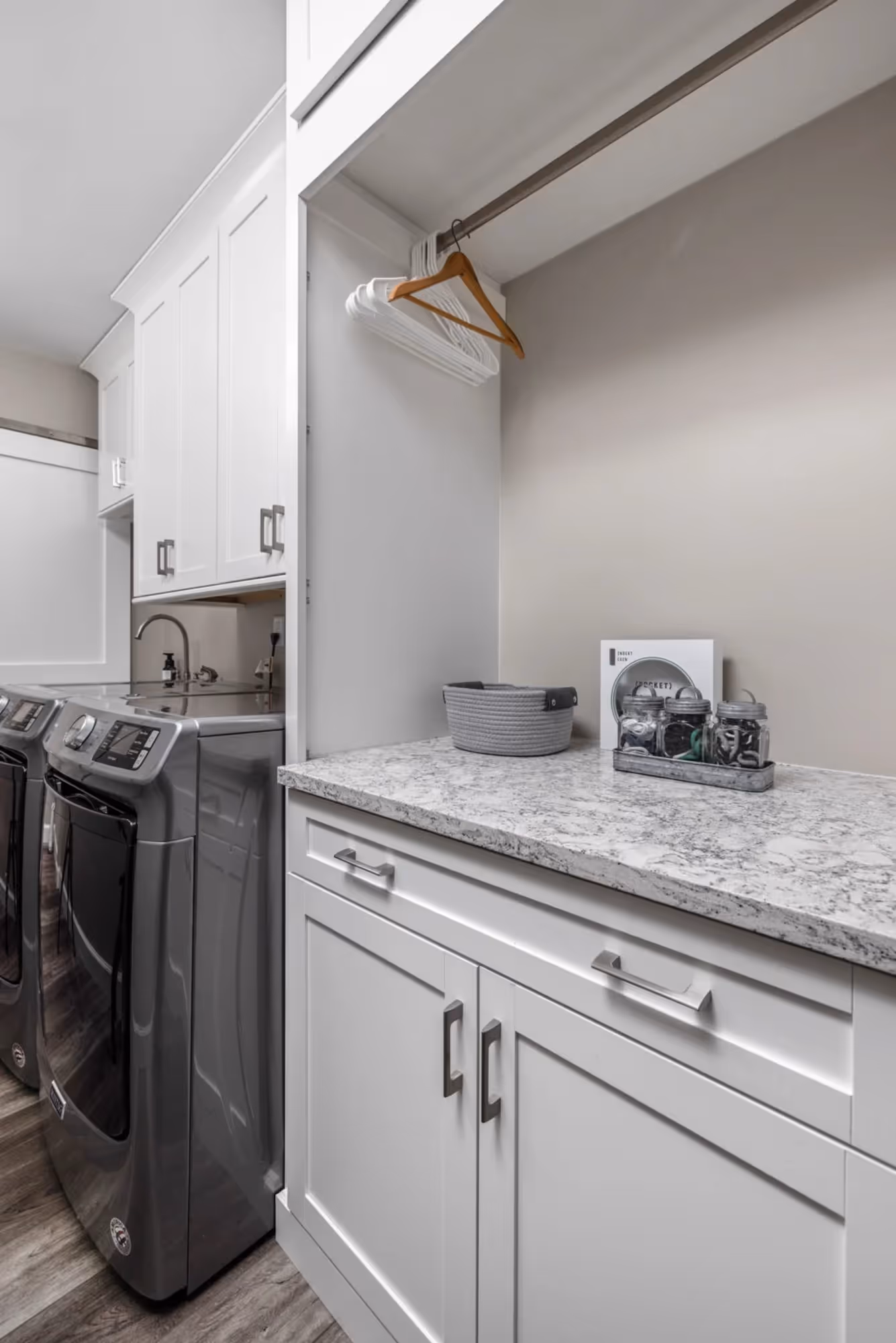 Compact laundry area with sink, countertop, and appliances.