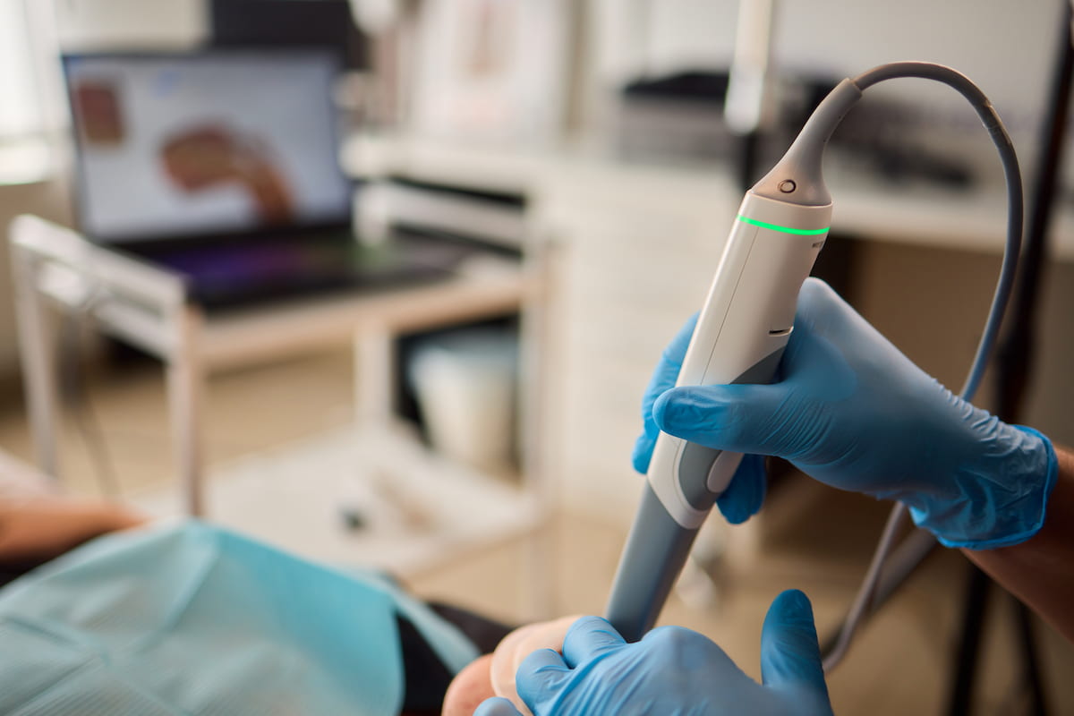 Dentist using Primescan intraoral scanner to take digital impression