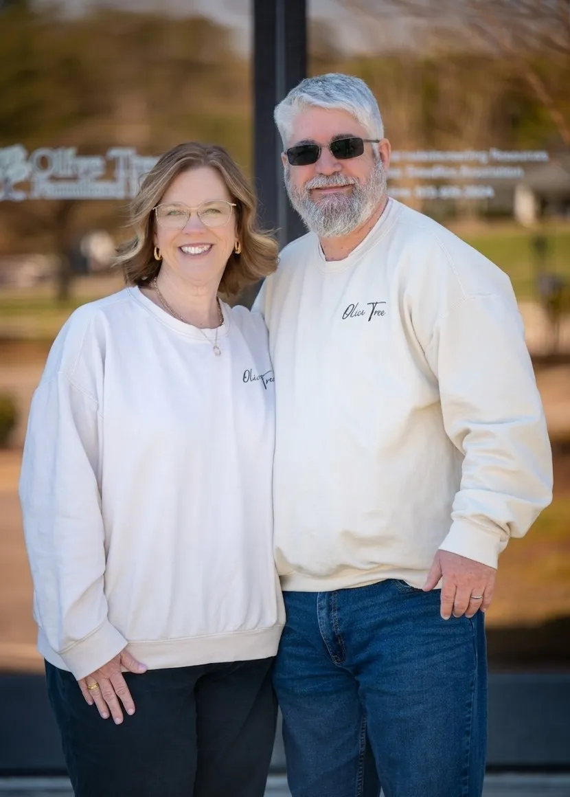 David and Cheryl Morrow of Olive Tree Family Counseling, standing in front of the Olive Tree facility