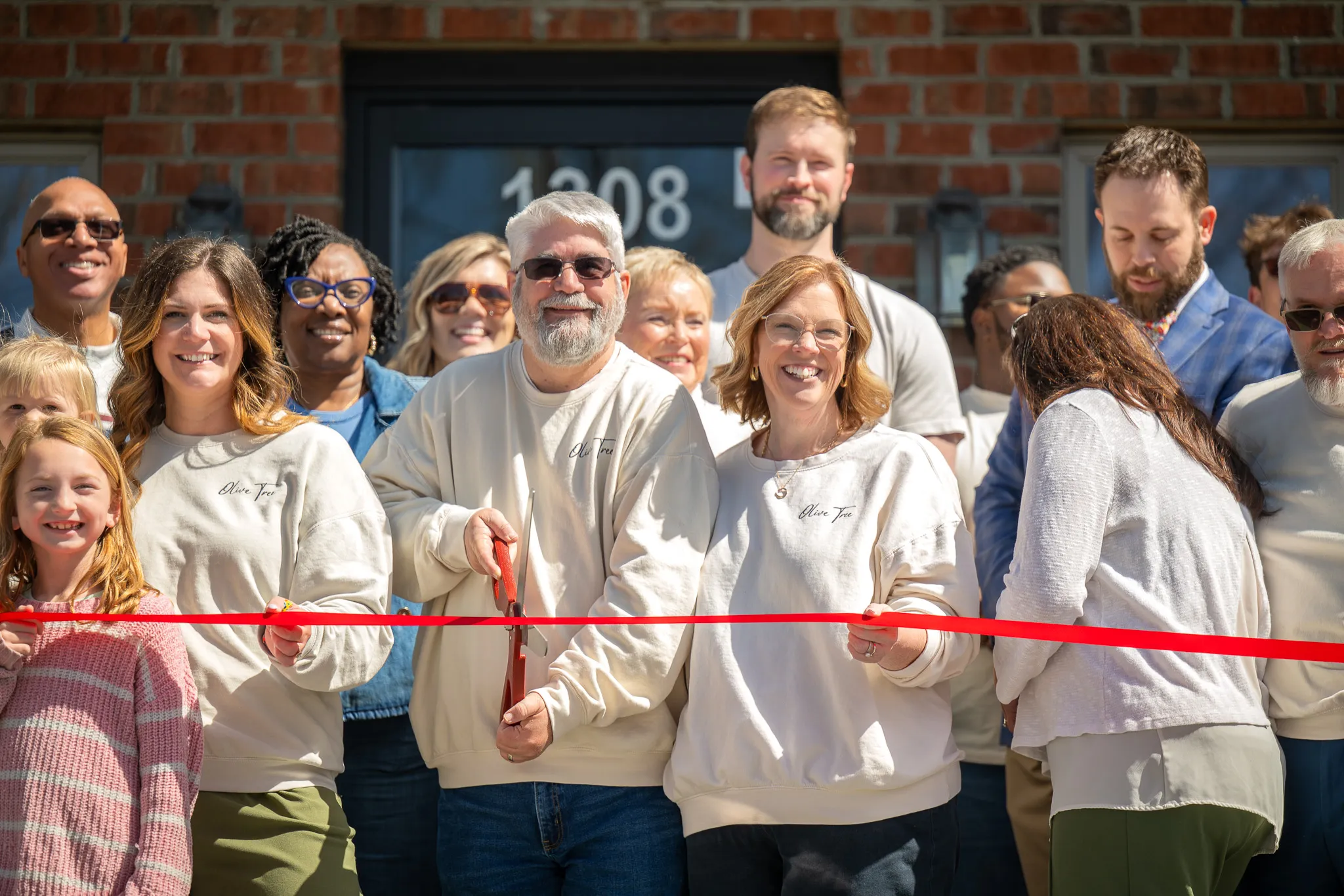 The team of Olive Tree Family Counseling celebrating the opening of a new location in New Bern, NC with a ribbon cutting.