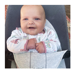 a baby smiling in a pram