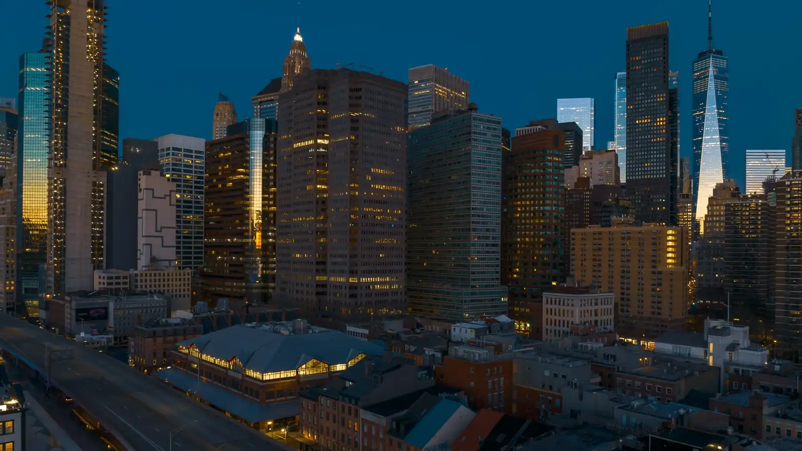 New York City towers at dawn with lit windows