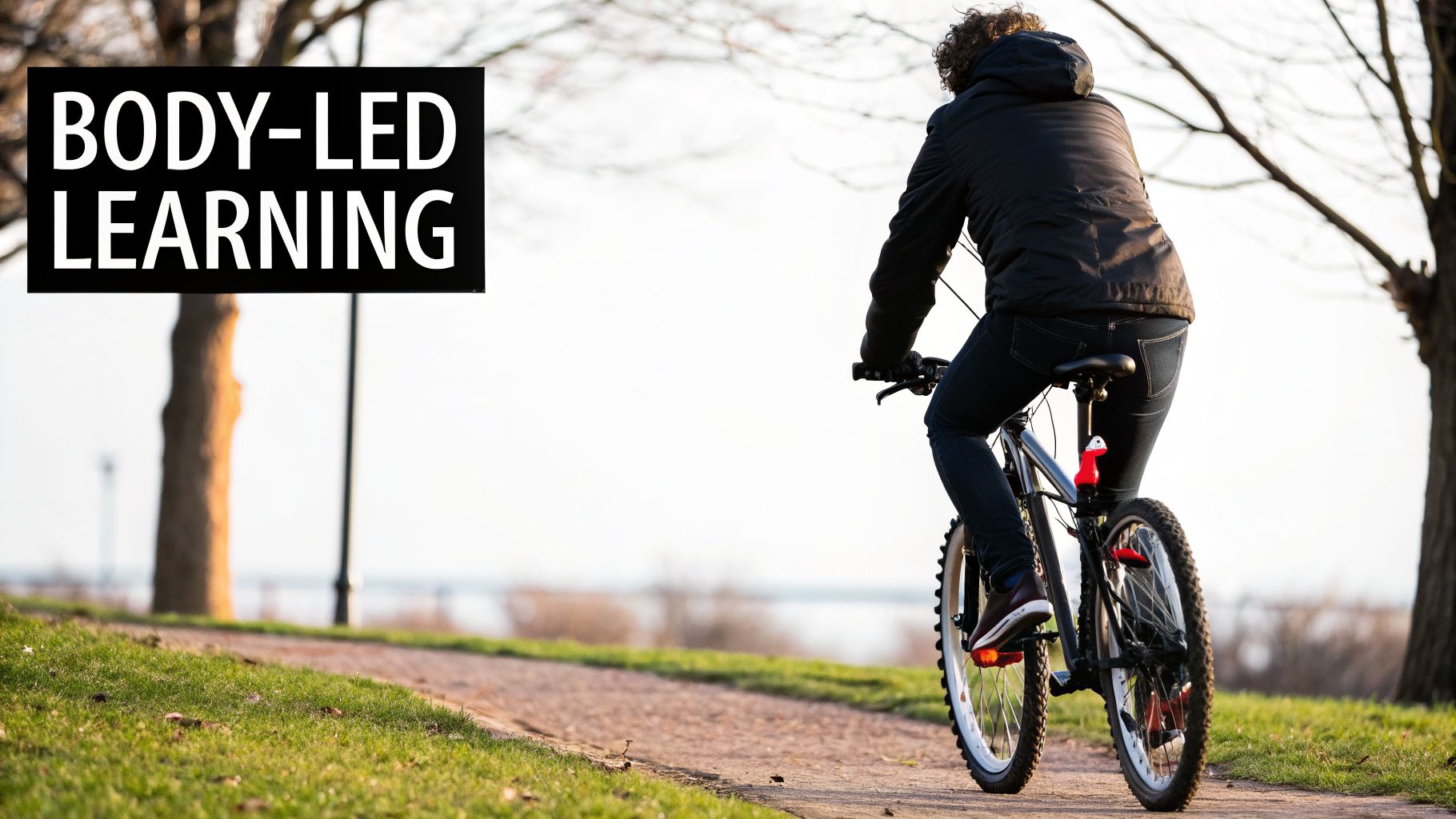A person riding a bicycle on an outdoor path, with text 'BODY-LED LEARNING' on the left.