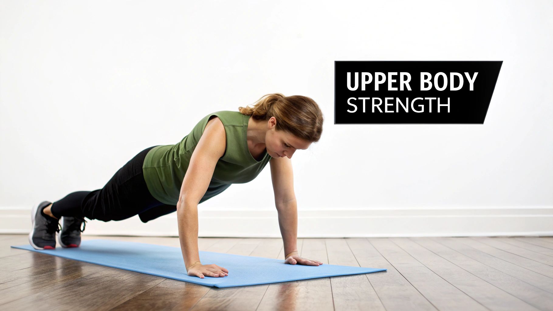 A woman in a green top performs a plank exercise on a blue yoga mat, emphasizing upper body strength.