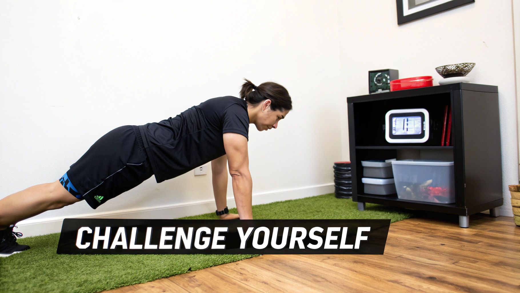 A person performing a plank exercise on a green mat with a 'CHALLENGE YOURSELF' sign.