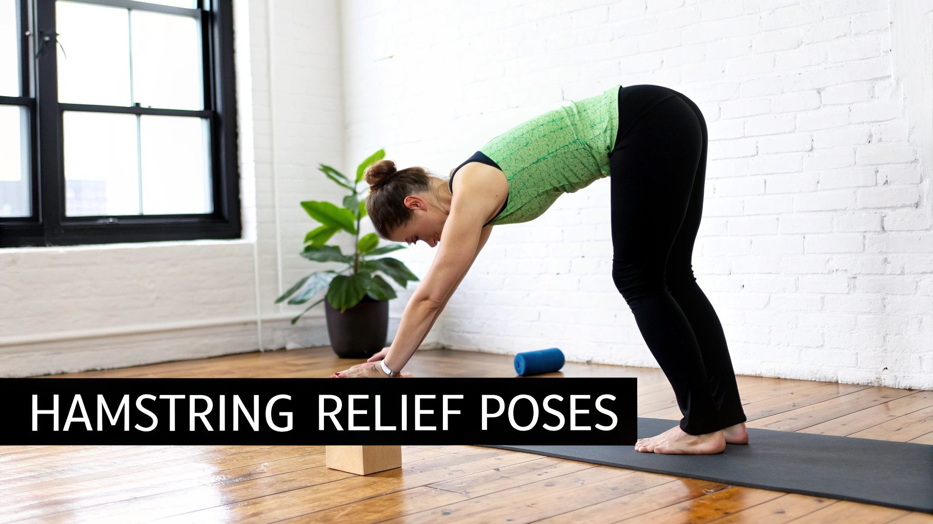 A woman performing a standing forward bend on a yoga mat for hamstring relief.