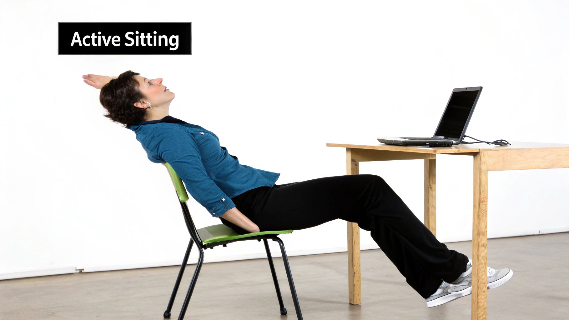 A woman demonstrating active sitting posture, stretching her back while seated at a desk.