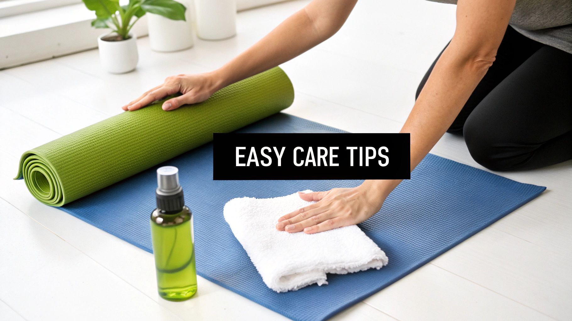 A person gently wiping down a cloth yoga mat with a spray bottle and cloth nearby.