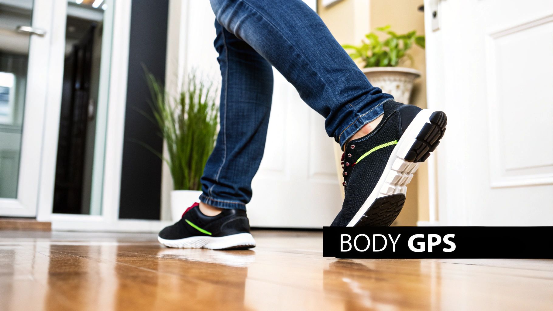 A person in blue jeans and black sneakers takes a step on a polished wooden floor, with 'BODY GPS' text.