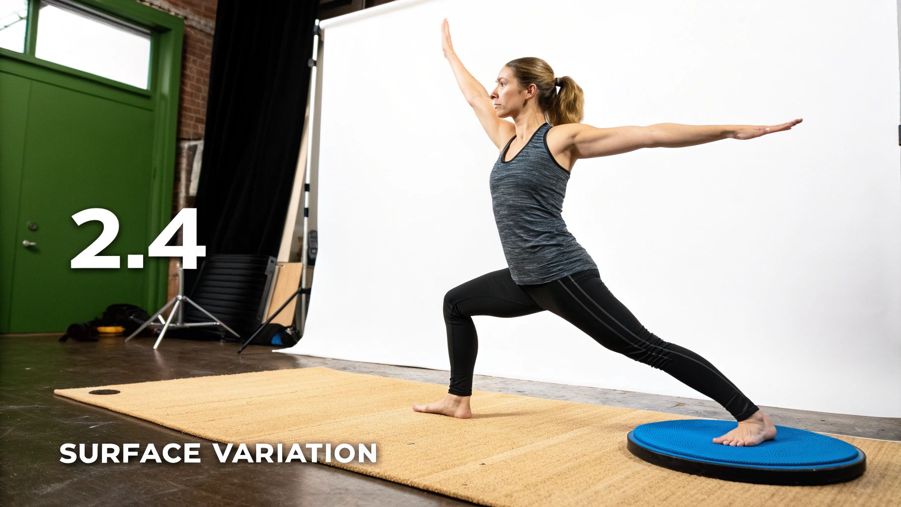 A woman performs a warrior yoga pose on a balance disc, demonstrating surface variation.