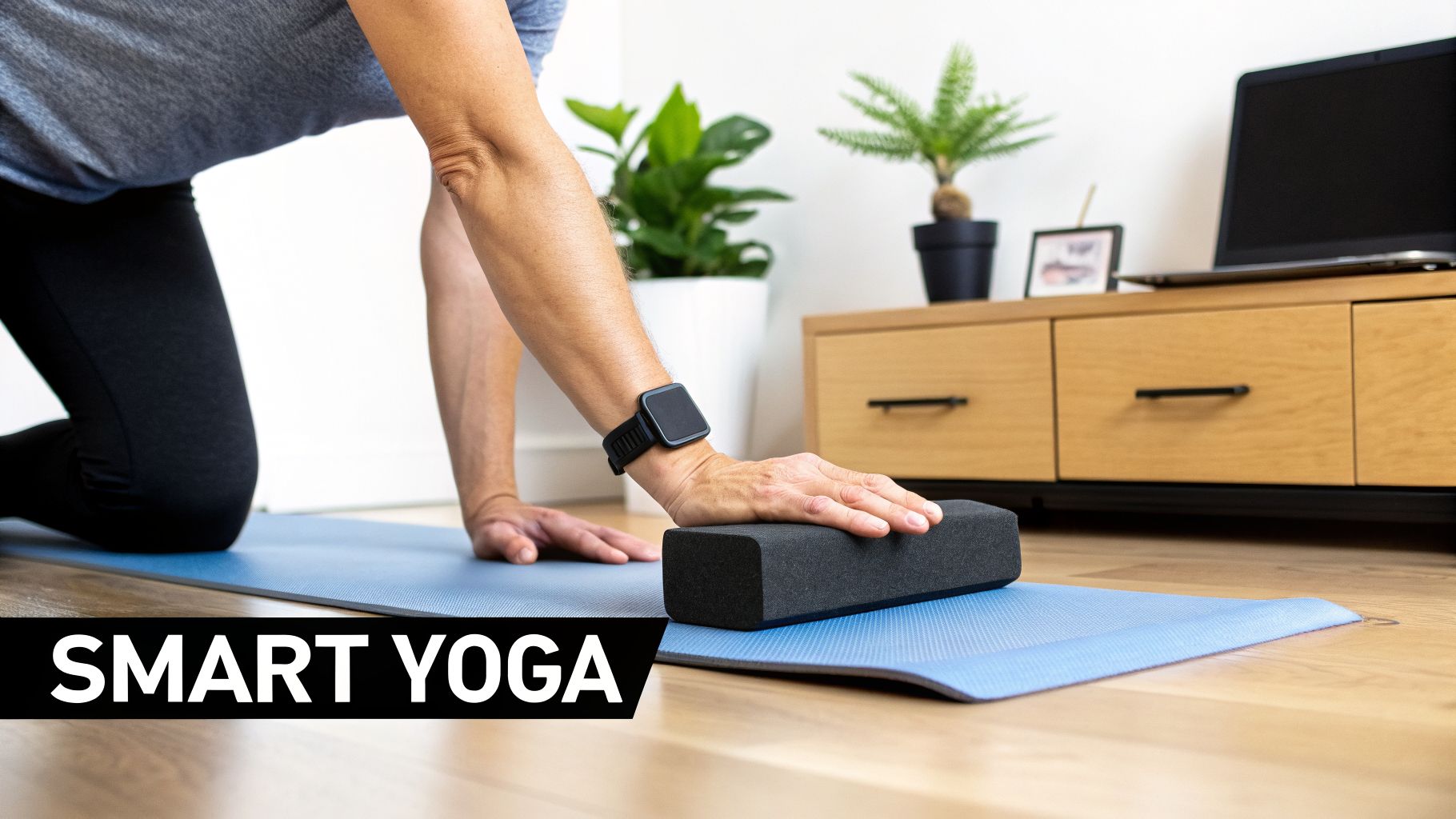 A person doing yoga indoors, wearing a smartwatch and using a yoga block on a blue mat.