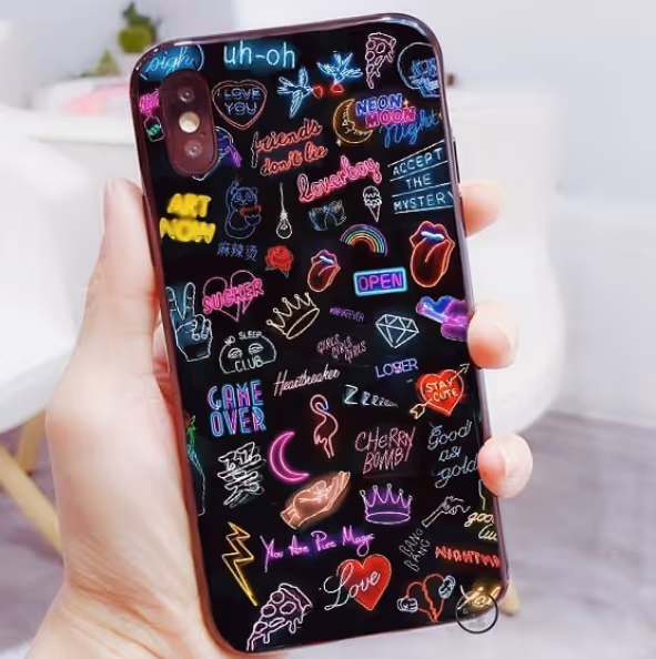 Teen girl holding black phone case with hand drawn doodles