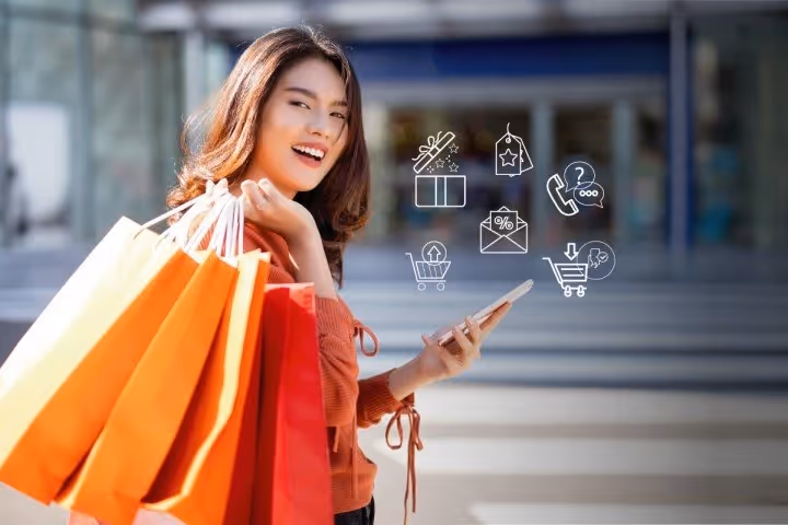 How to Increase Customer Lifetime Value in Ecommerce-a woman holding shopping bags and a phone