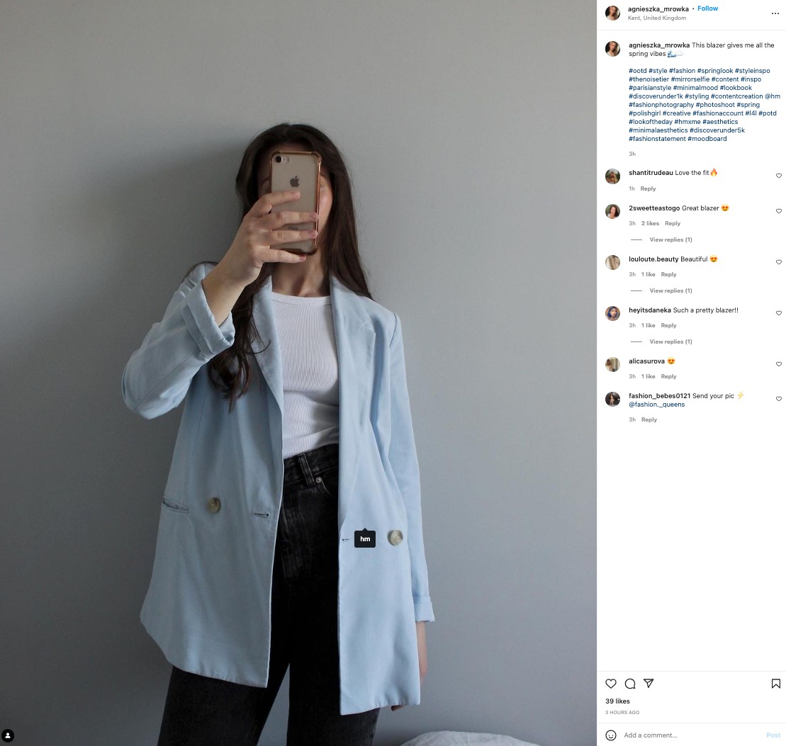 An H&M customer posting a selfie wearing her H&M blazer