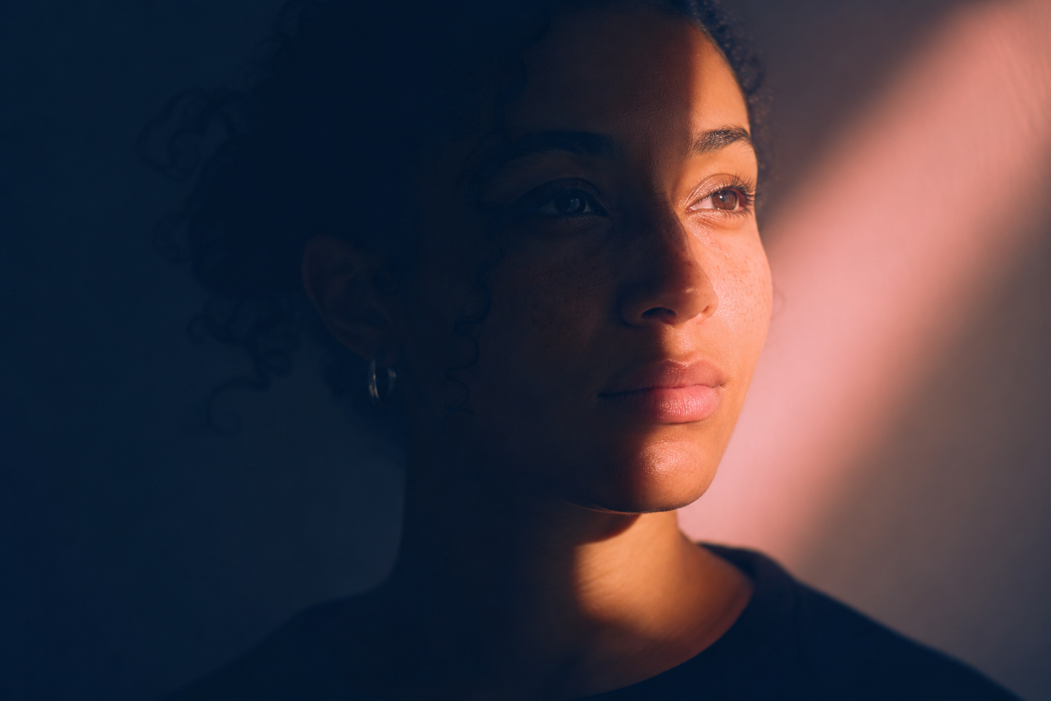 A close portrait of a shopper with half the face lit and half in shadow.