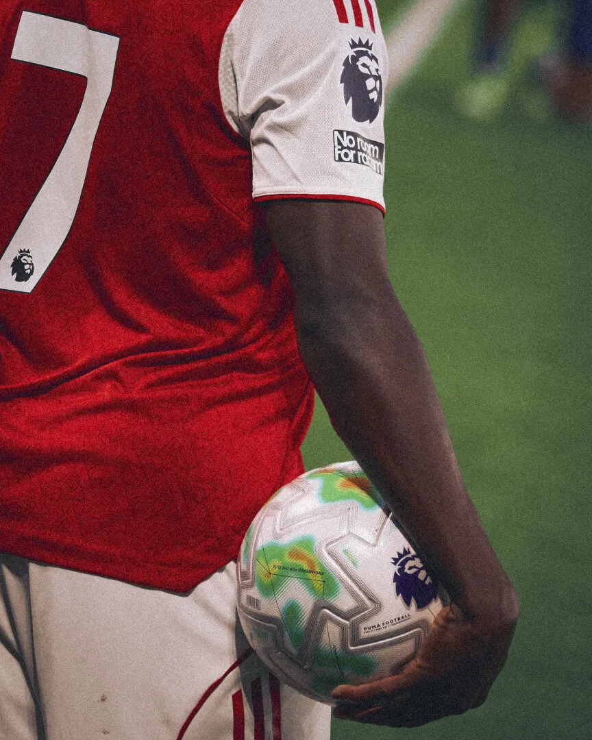 Bukayo Saka, Arsenal football player holding a Premier League football.