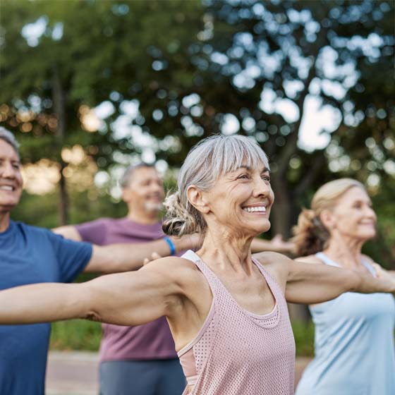 Group of middle aged people exercising outside