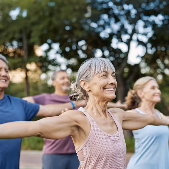 Group of middle aged people exercising outside