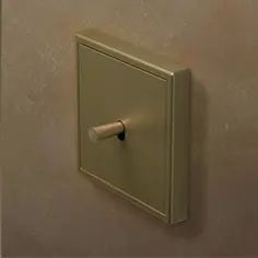 Beige schakelaar voor verlichting aan een crèmekleurige muur.