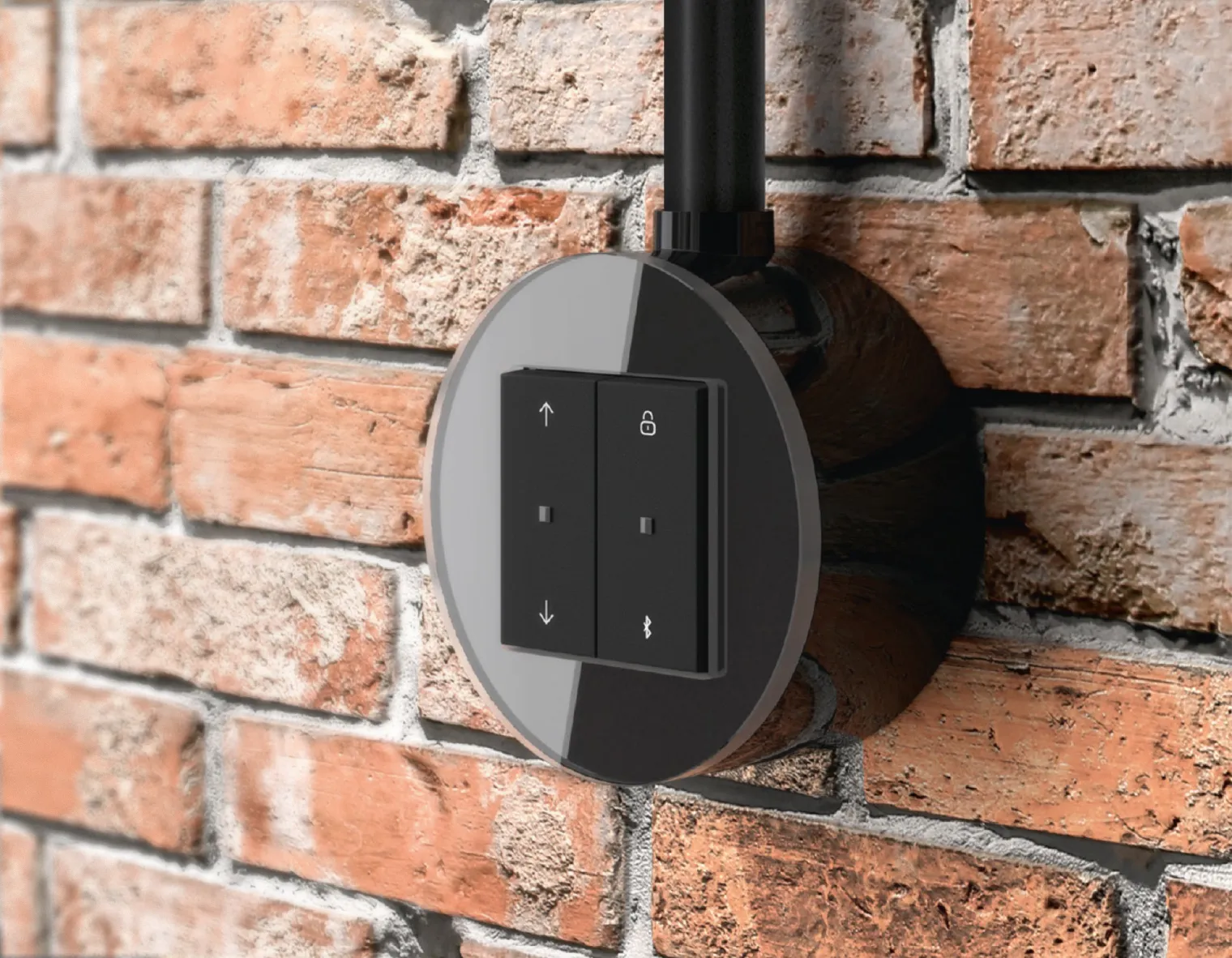 een zwarte Gira Studio opbouw KNX schakelaar uitgevoerd met zwart glas, gemonteerd op een bakstenen muur