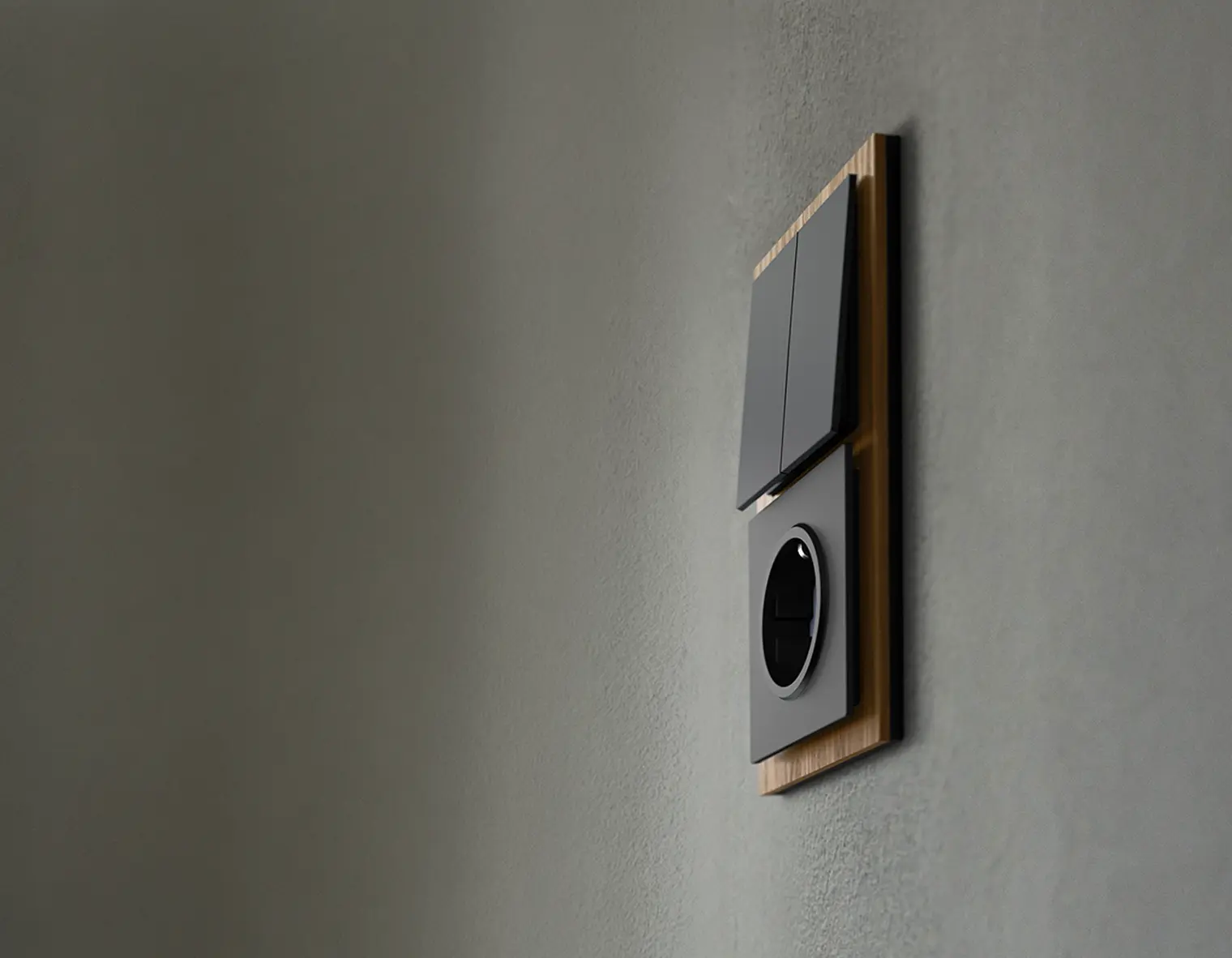 Een warmgrijze wand met daarop een zwarte schakelaar en stopcontact-combinatie uit de Art Linear serie uitgevoerd met afdekraam van walnoot-hout