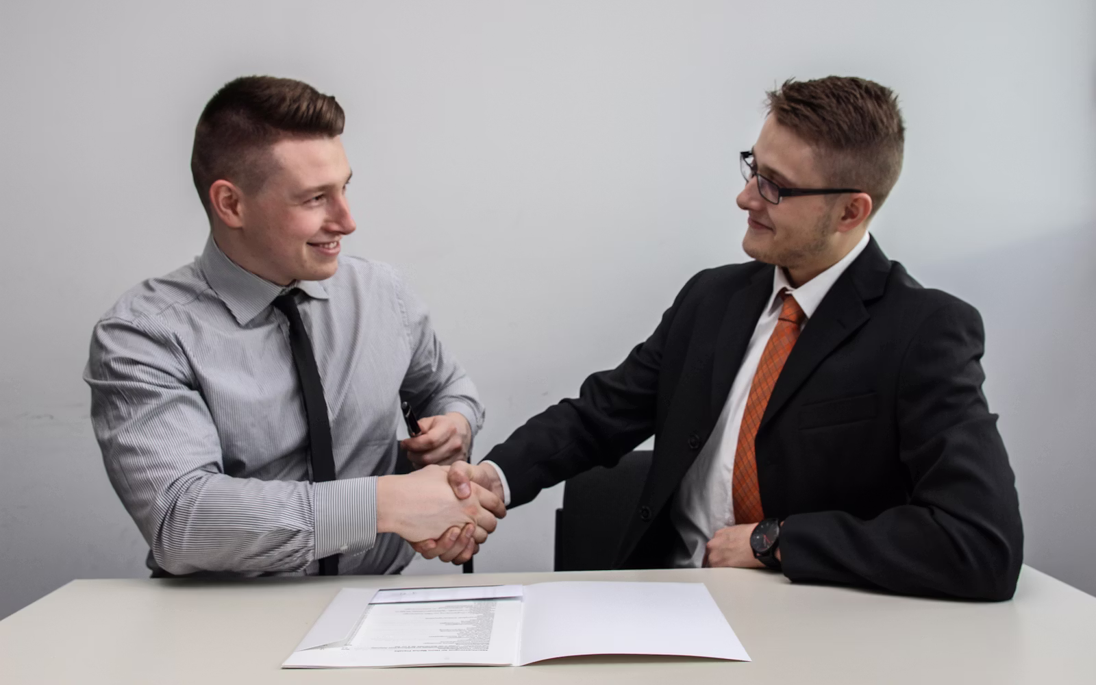 Two business partners shaking hands after a reseller agreement