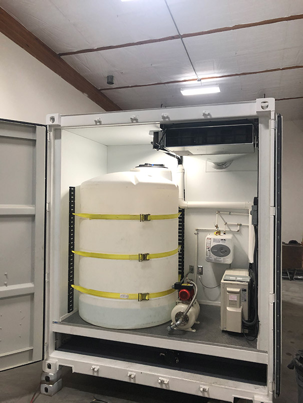 Off-grid shipping container bathroom mechanical room