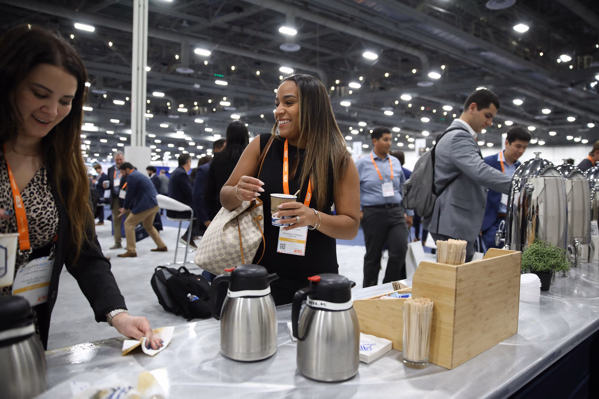People at a coffee station interacting and serving coffee at the 2025 NBAA-BACE Coffee Social