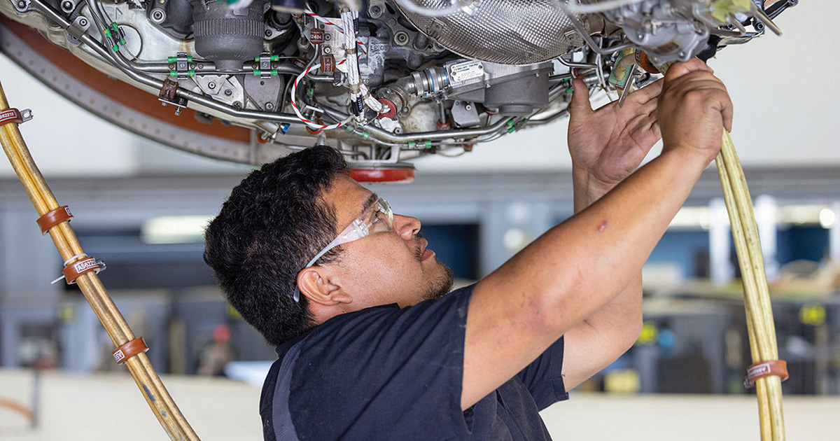Maintenance technician working on a jet engine