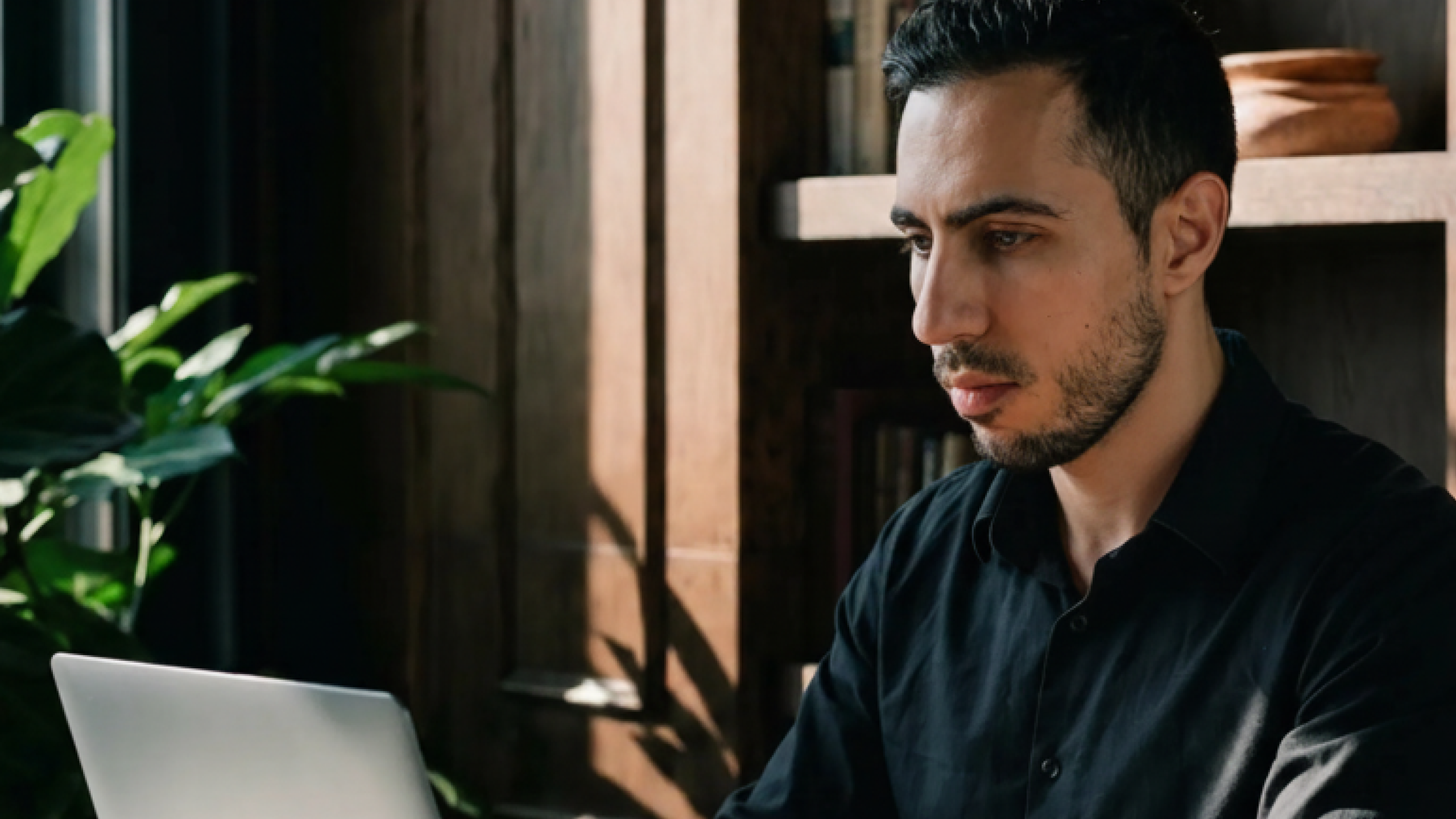 Armen, a CPA, works on a laptop.