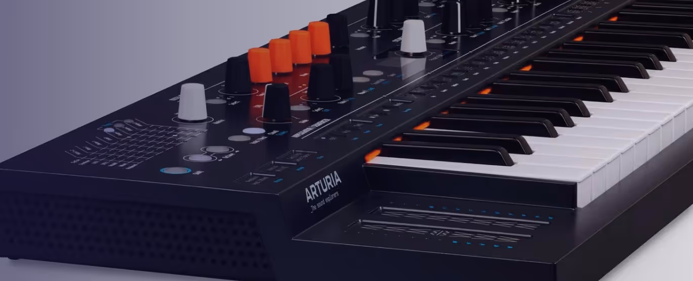Close-up of an Arturia synthesizer keyboard with control knobs and sliders.