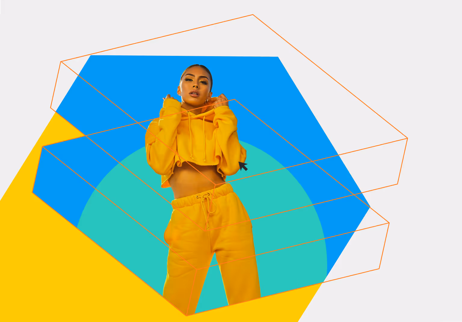 Woman wearing a yellow cropped hoodie and matching pants standing against a colorful geometric background.