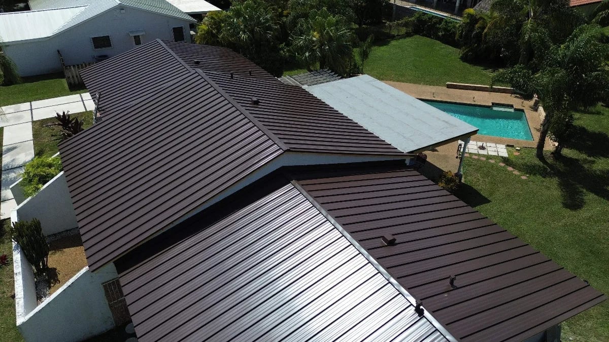 Professional roofer installing tiles on South Florida home
