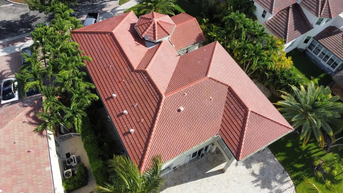 Tile roof expert performing assessment on South Florida home