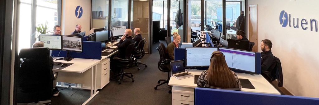 Inside the office, showing the team working at their desks.