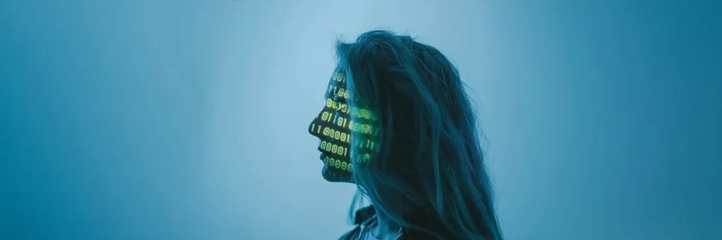 A woman with 1's and 0's projected onto her face to illustrate AI.