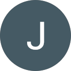 Circle with dark blue-gray background and a white capital letter J in the center.