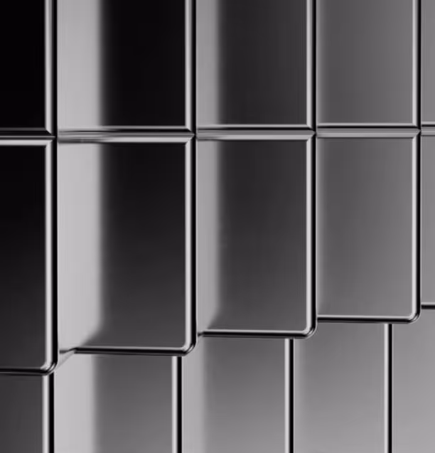 Close-up of shiny black rectangular tiles with rounded edges arranged in rows.