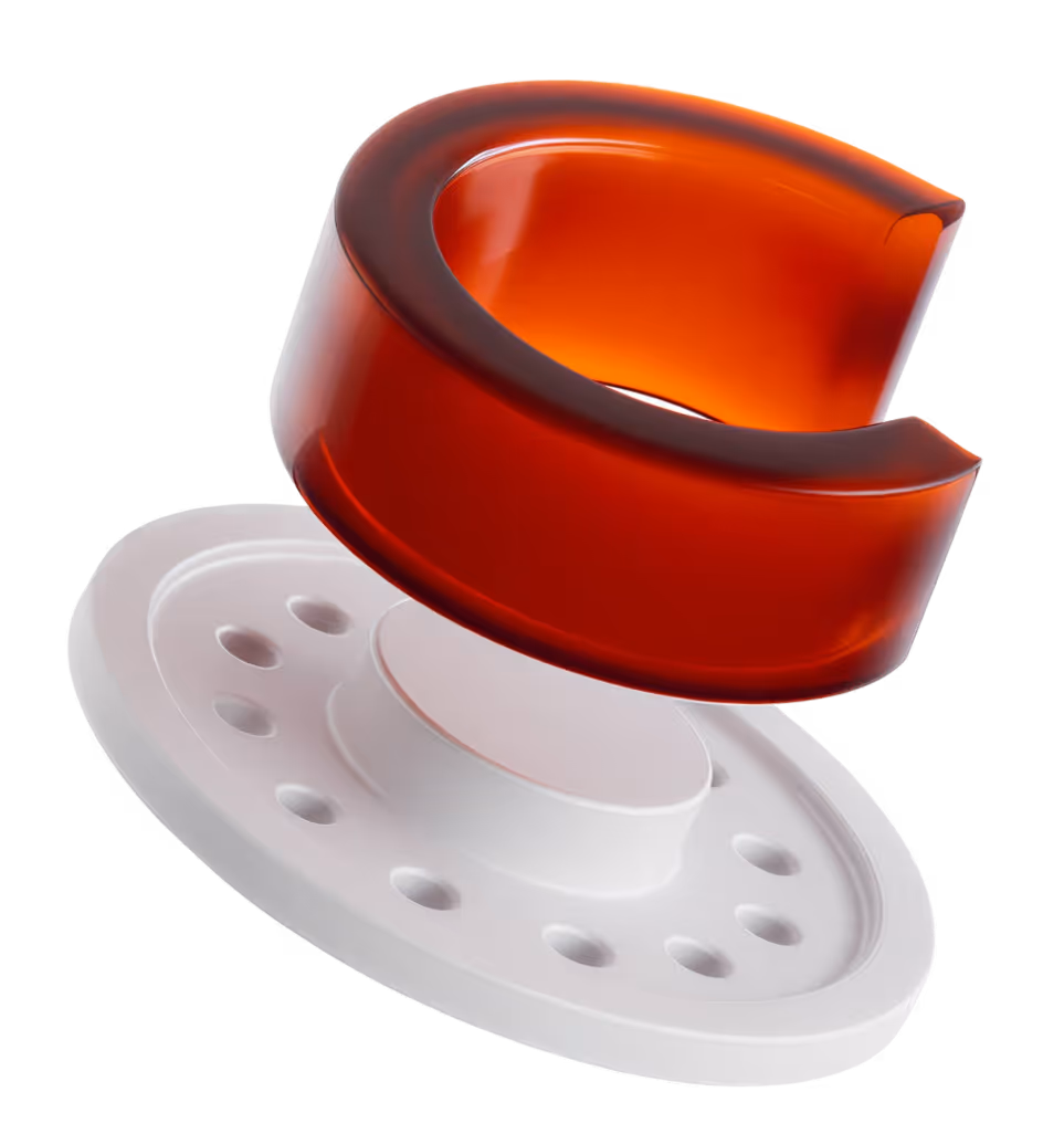Red translucent ring floating above a white oval disk with holes and a raised center.