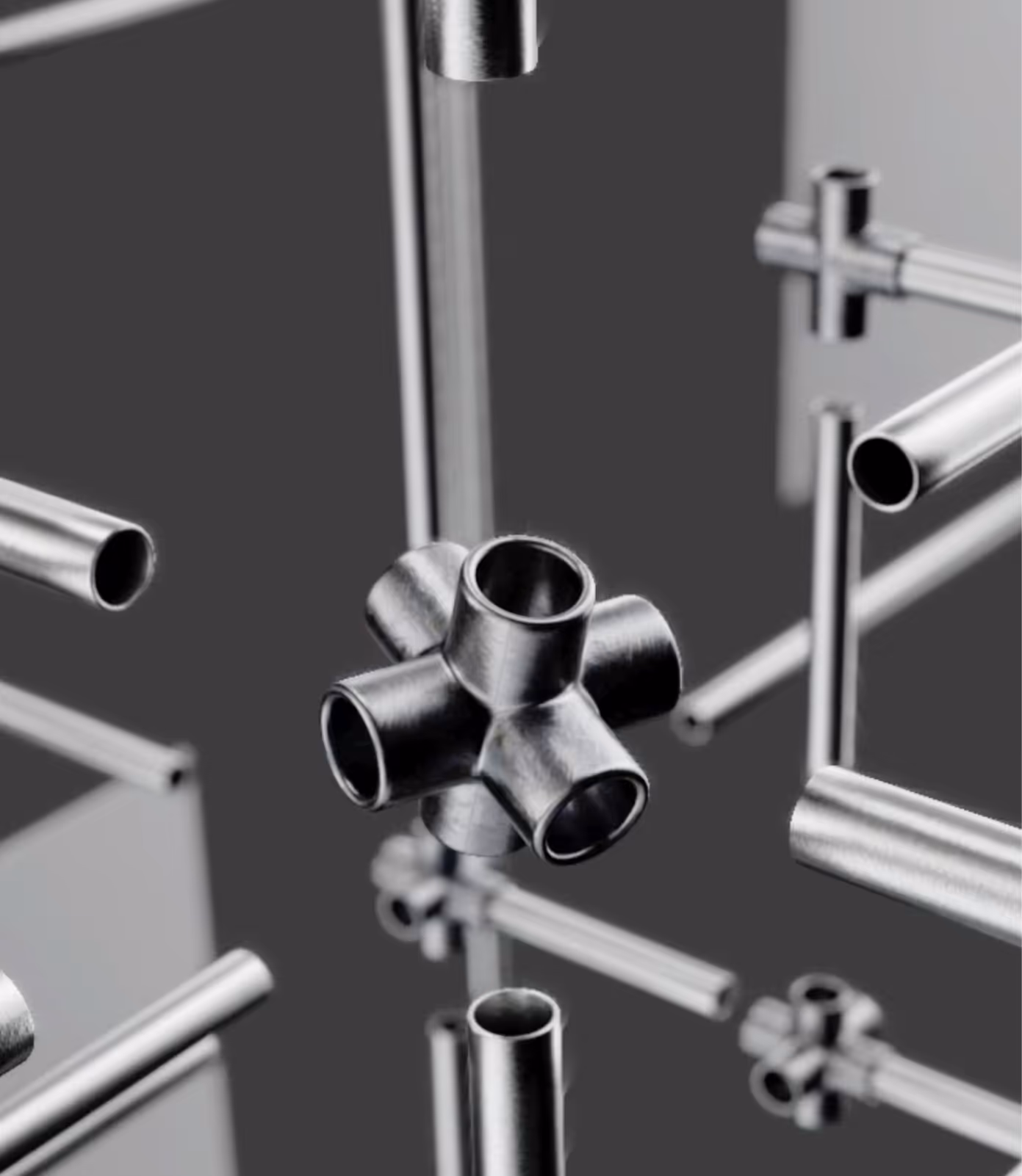 Metal pipes and connectors appear suspended, forming a complex structure on a gray background.