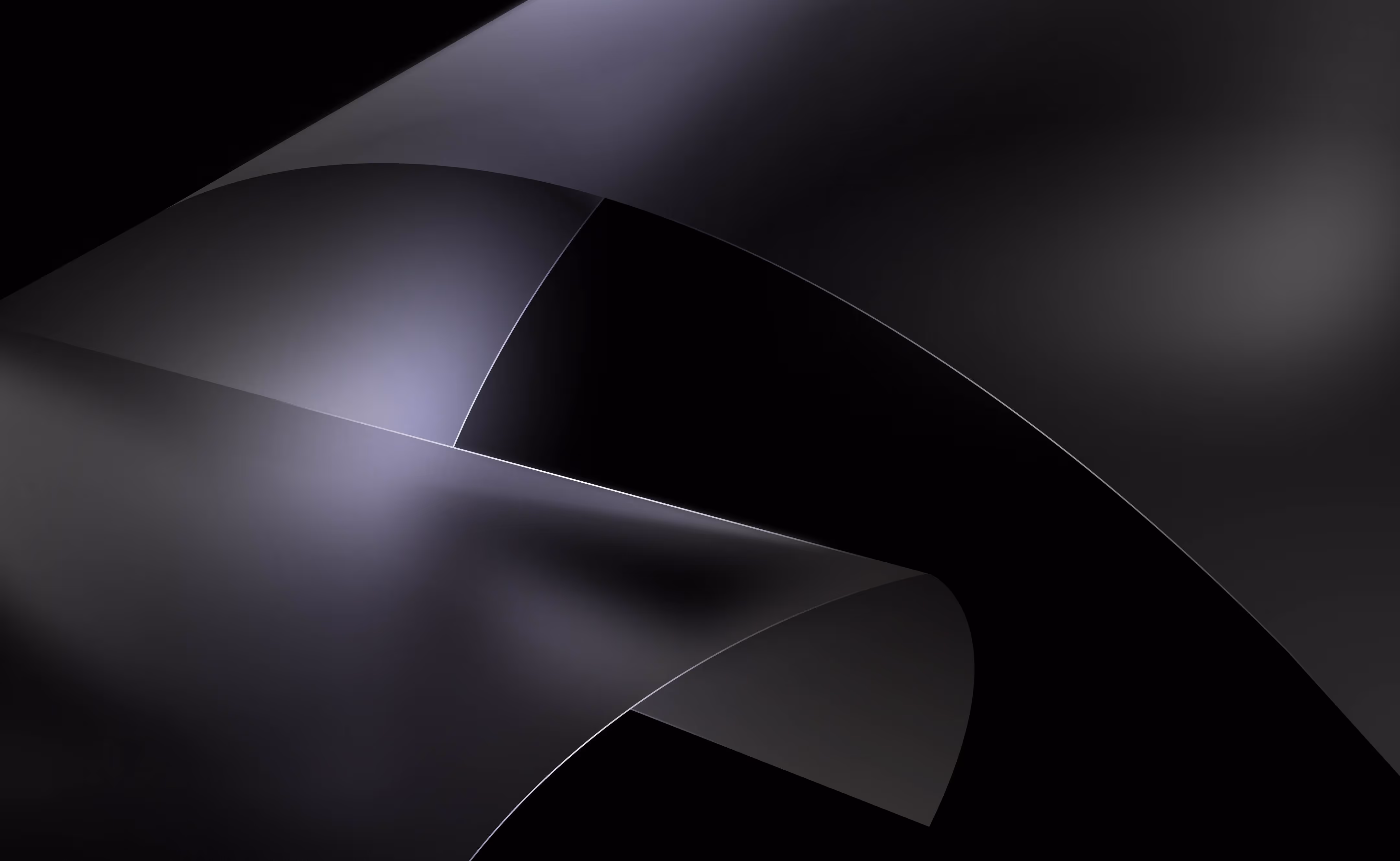 Curved, overlapping dark gray and black metallic sheets with smooth, reflective surfaces.