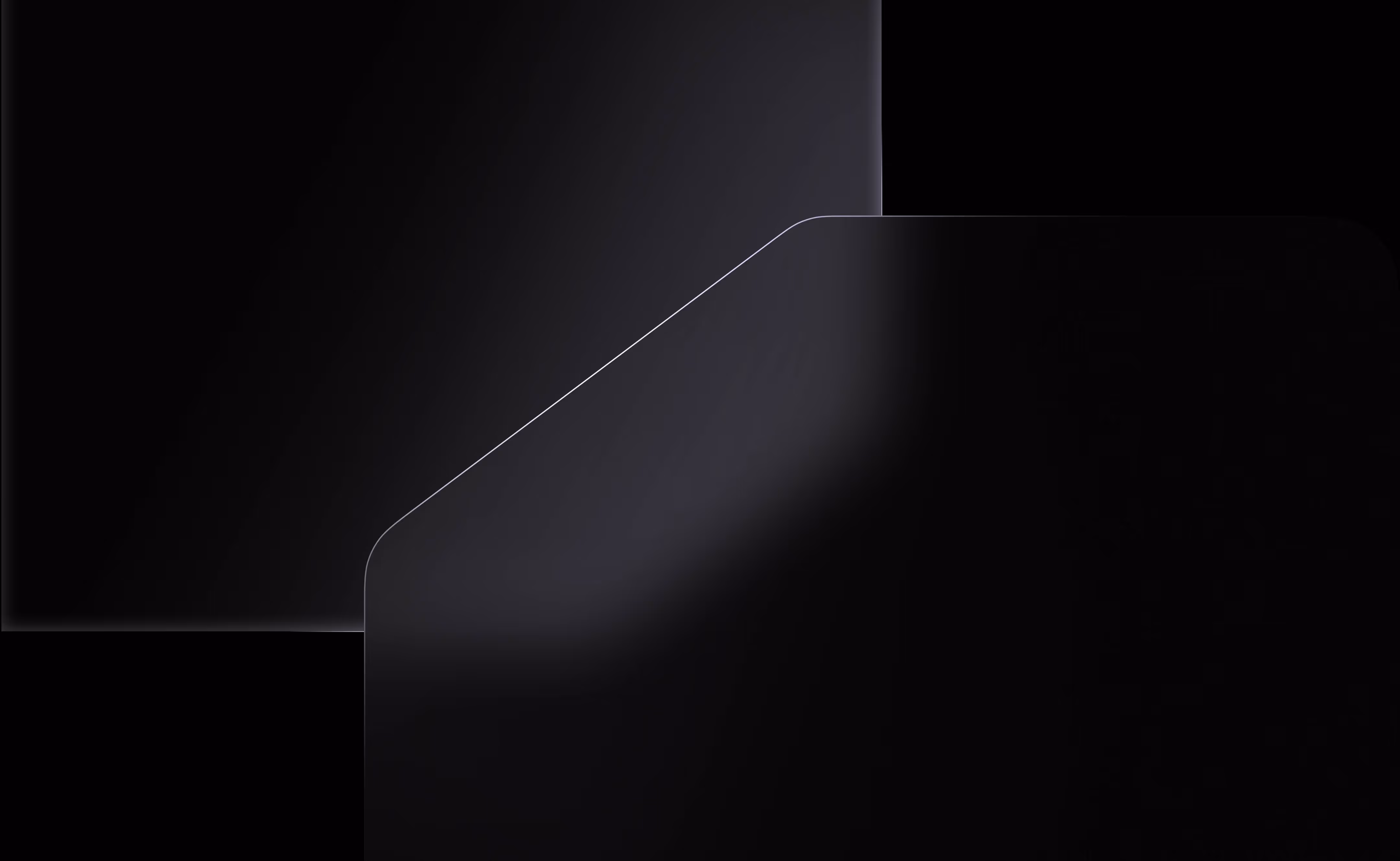 Close-up of two dark screens with rounded corners and faint reflections.